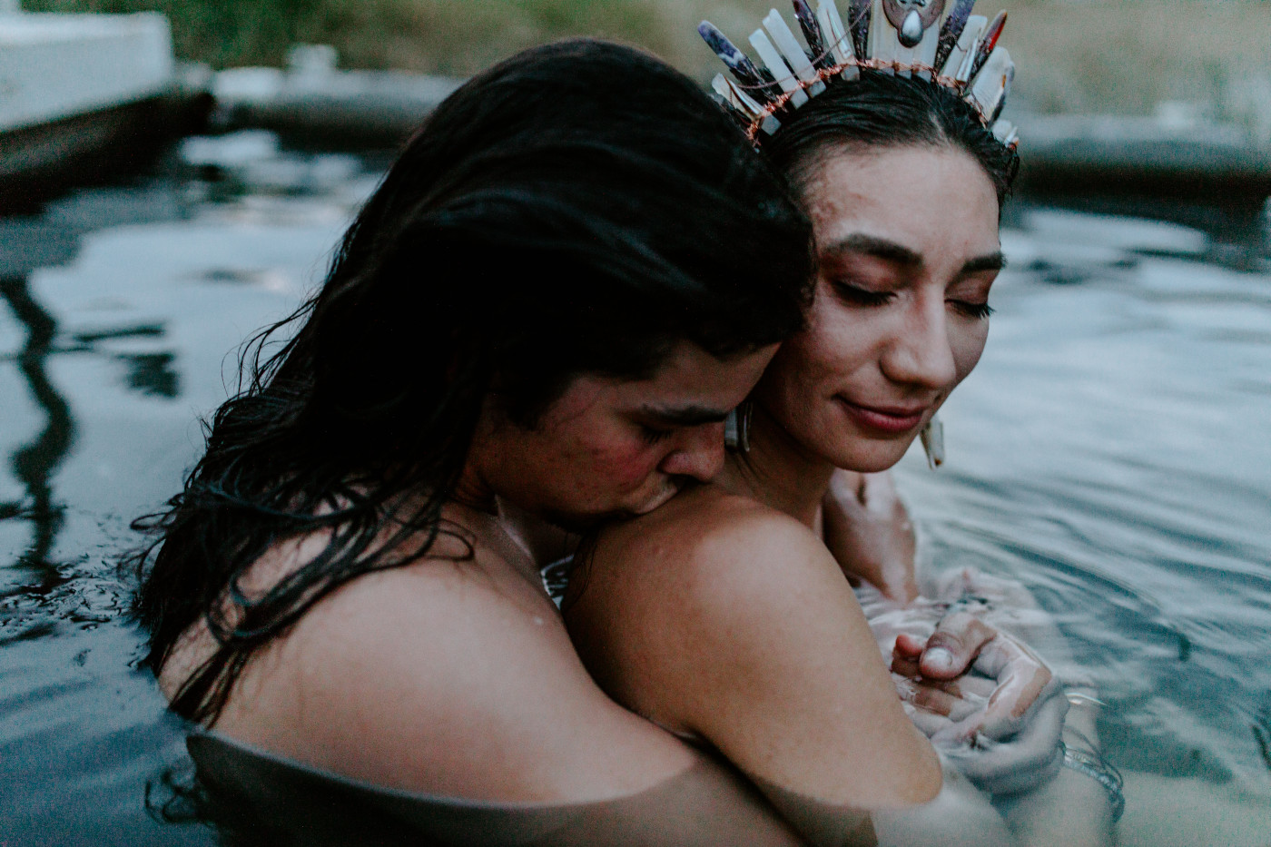 Emerald and Cameron hug in the hot springs.