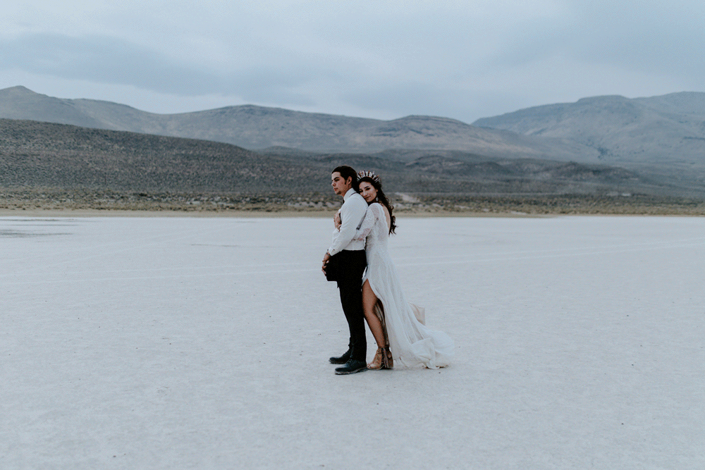 An animated gif of Emerald and Cameron standing in the wind of Alvord Desert.