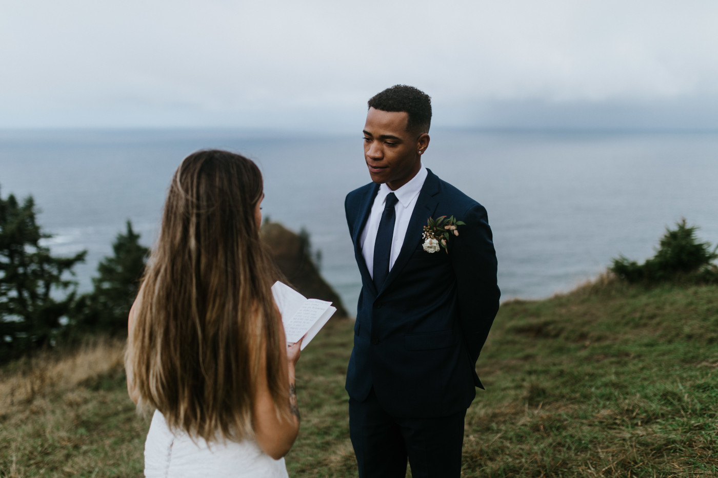 Ariana and Deandre stand face to face as Ariana reads. Elopement photography at Mount Hood by Sienna Plus Josh.