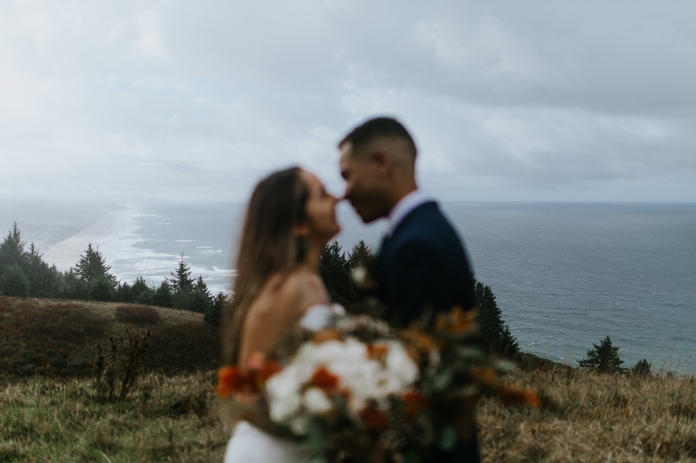 The Oregon coast sprawls out behind Ariana and Deandre. Elopement photography at Mount Hood by Sienna Plus Josh.