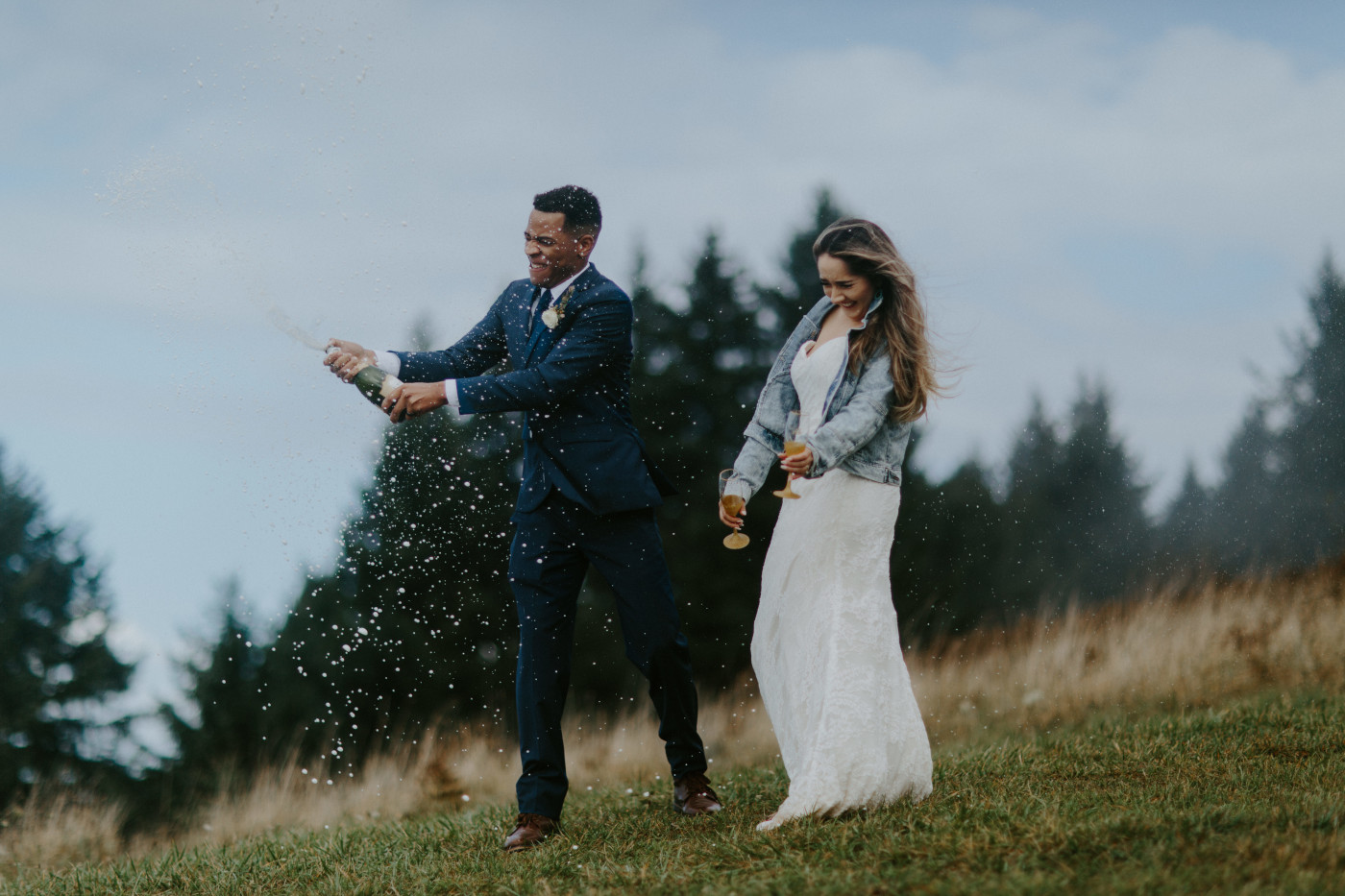 Deandre and Ariana get sprayed by the champagne. Elopement photography at Mount Hood by Sienna Plus Josh.