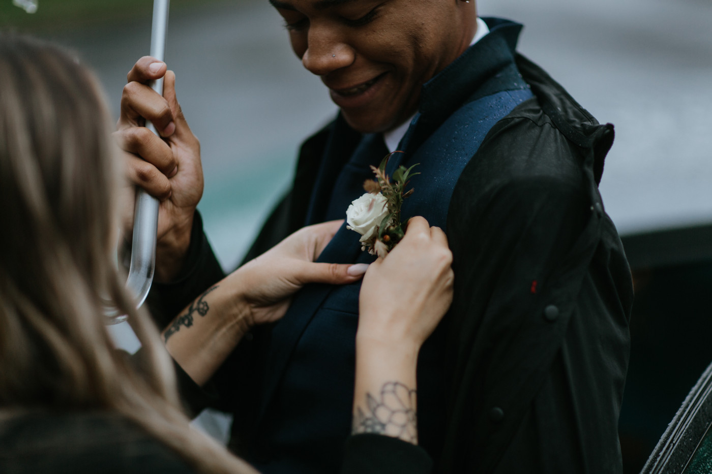 Ariana pins Deandre's boutonniere to him. Elopement photography at Mount Hood by Sienna Plus Josh.