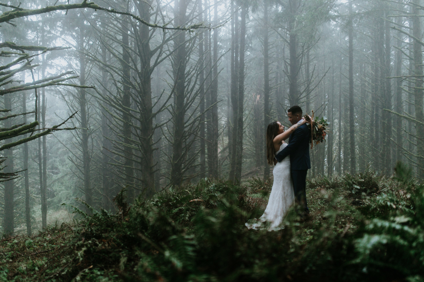 Deandre and Ariana hold each other in the woods. Elopement photography at Mount Hood by Sienna Plus Josh.