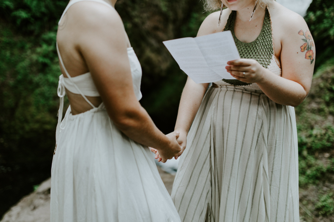 Audrey and Kate hold hands. Elopement wedding photography at Bridal Veil Falls by Sienna Plus Josh.