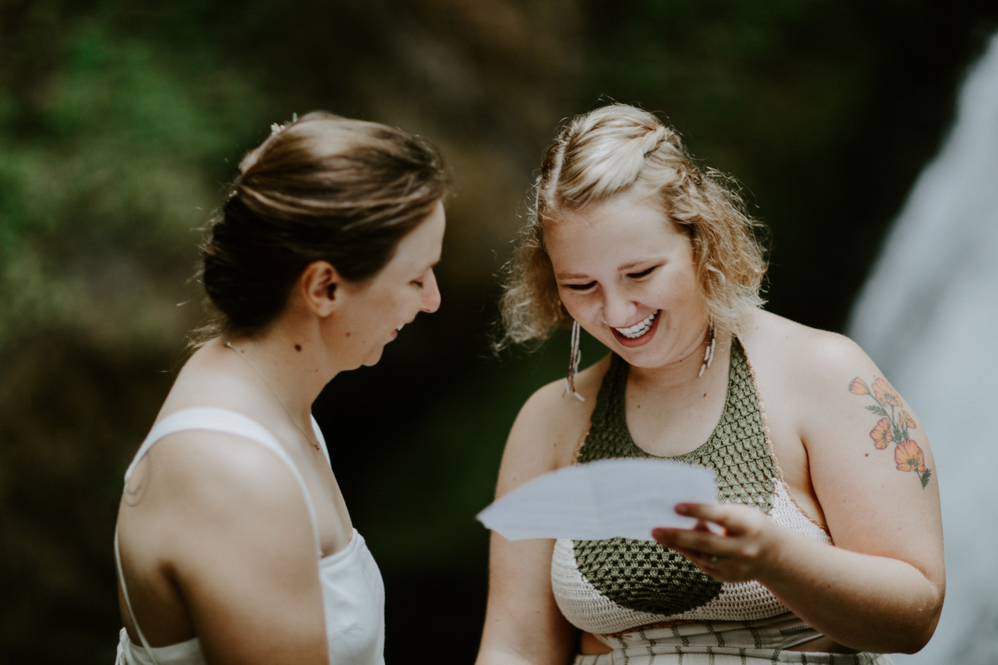 Kate reads her vows to Audrey in front of the waterfall at Bridal Veil Falls. Elopement wedding photography at Bridal Veil Falls by Sienna Plus Josh.