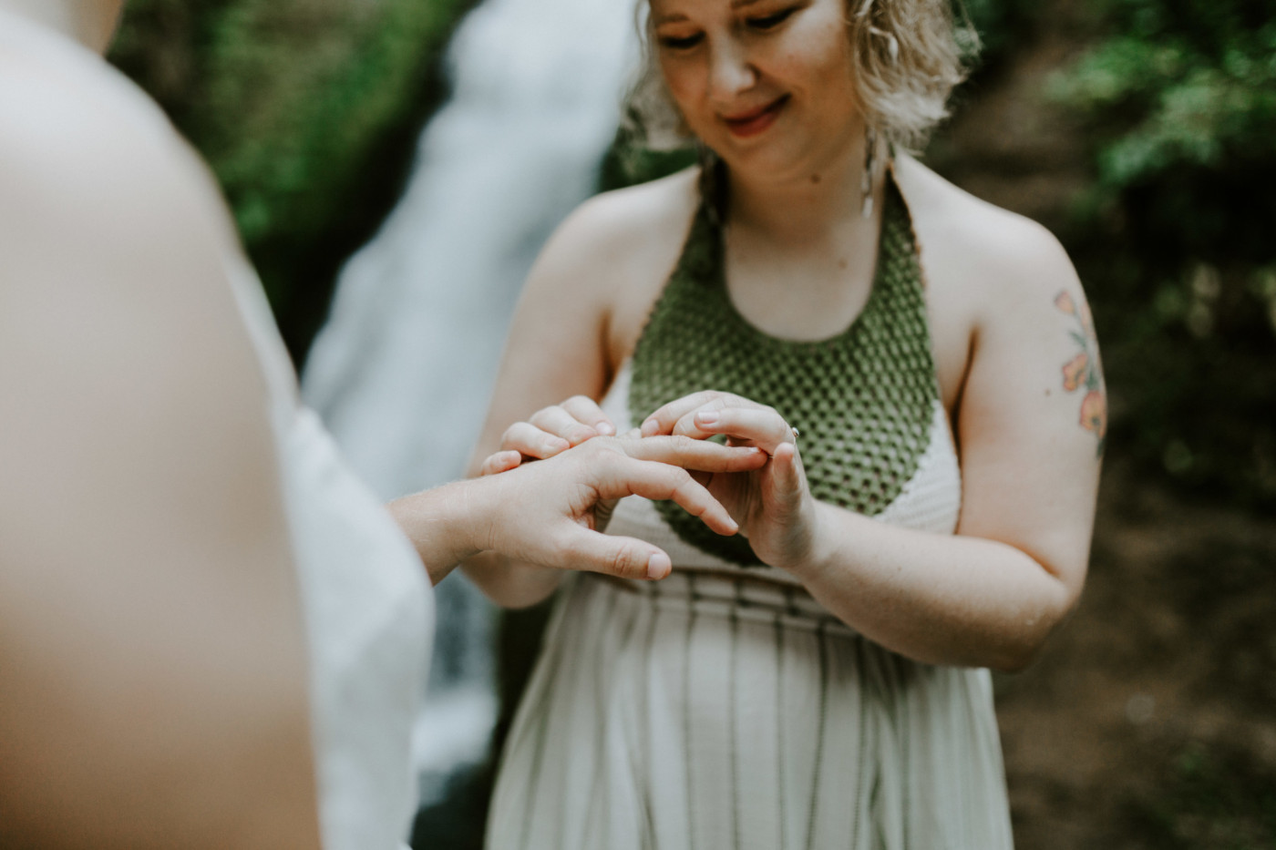 Kate puts a ring on Audrey. Elopement wedding photography at Bridal Veil Falls by Sienna Plus Josh.