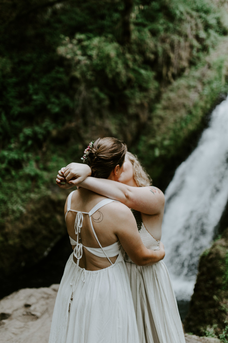 Kate and Audrey kiss in front of Bridal Veil Falls. Elopement wedding photography at Bridal Veil Falls by Sienna Plus Josh.