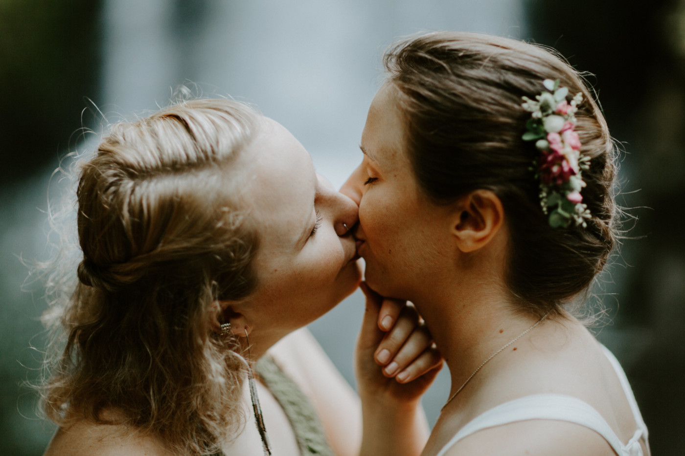 Kate brings Audrey in for a kiss. Elopement wedding photography at Bridal Veil Falls by Sienna Plus Josh.
