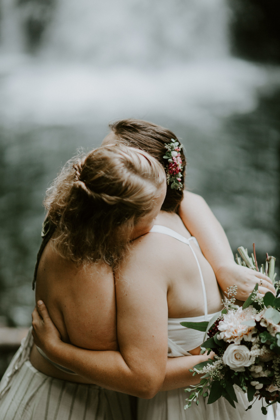 Audrey and Kate hug. Elopement wedding photography at Bridal Veil Falls by Sienna Plus Josh.