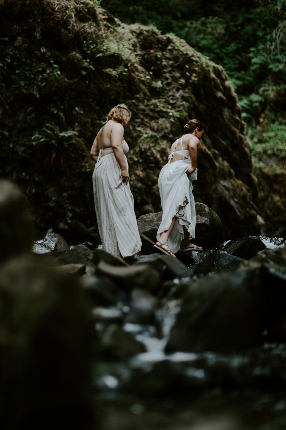 Kate and Audrey cross the river. Elopement wedding photography at Bridal Veil Falls by Sienna Plus Josh.