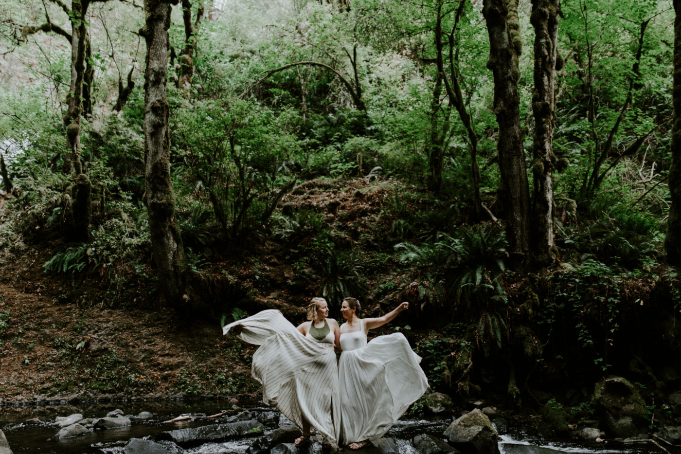 Audrey and Kate toss their dresses to the side. Elopement wedding photography at Bridal Veil Falls by Sienna Plus Josh.