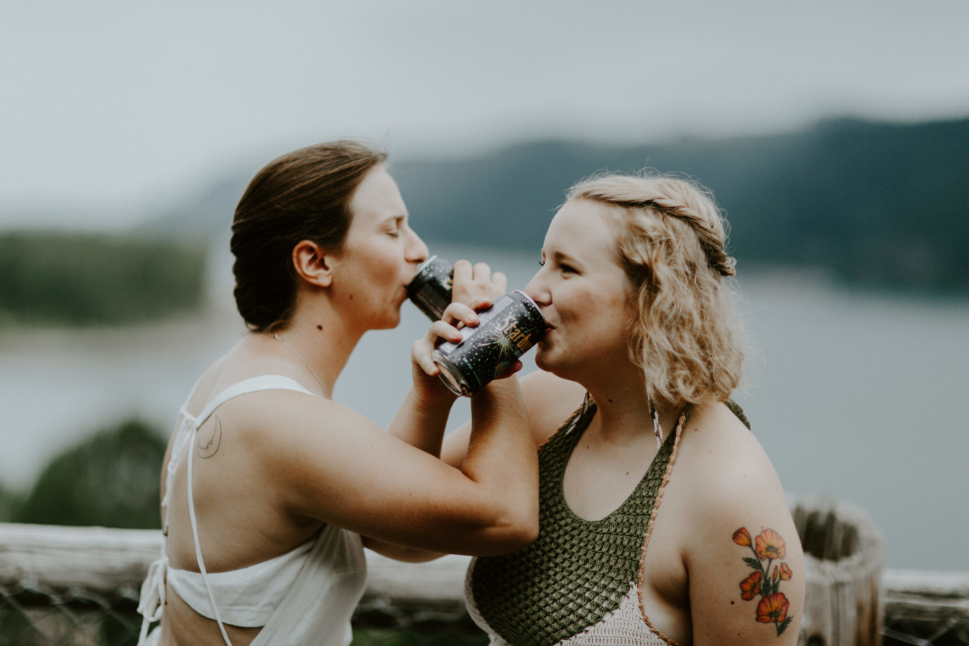 Kate and Audrey take a sip of their drinks. Elopement wedding photography at Bridal Veil Falls by Sienna Plus Josh.