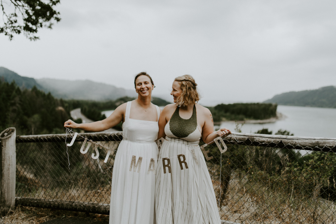Kate and Audrey hold up their just married banner. Elopement wedding photography at Bridal Veil Falls by Sienna Plus Josh.