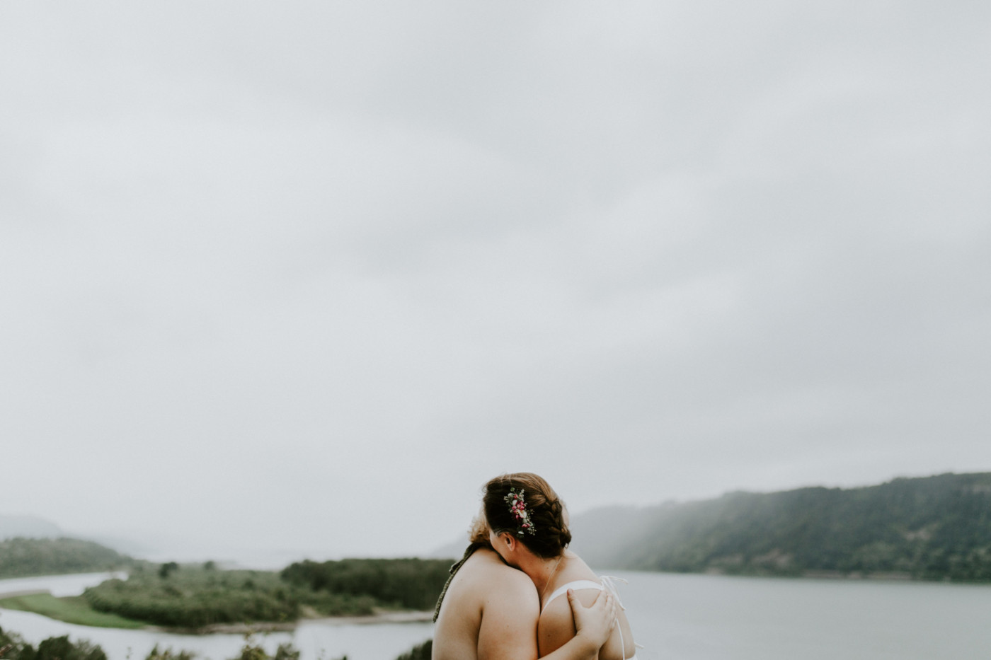 Audrey and Kate stand in front of the Columbia River. Elopement wedding photography at Bridal Veil Falls by Sienna Plus Josh.