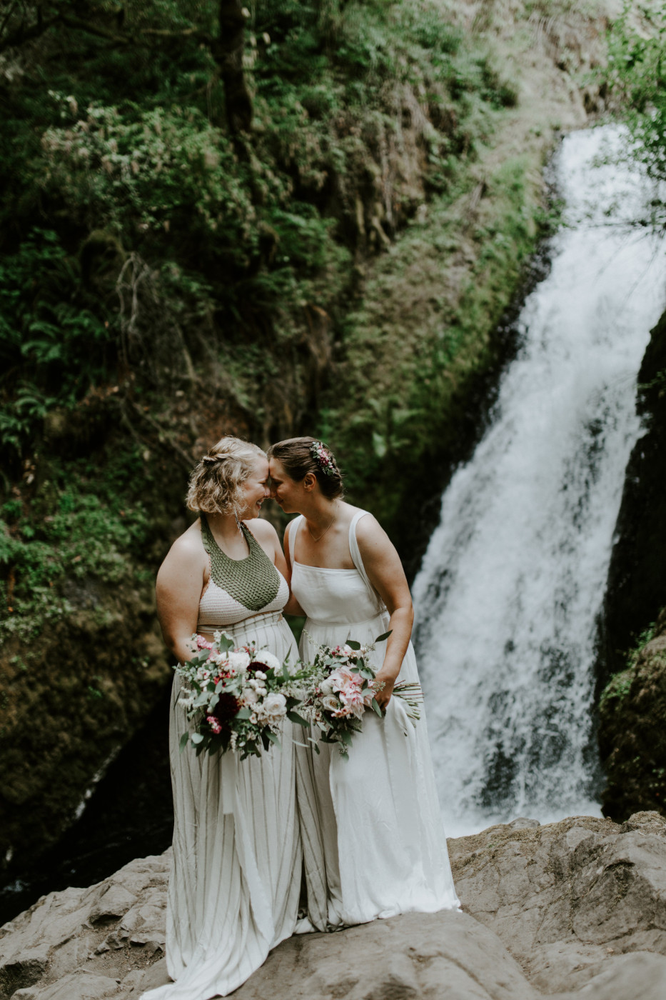 Audrey and kate put their foreheads together in front of Bridal Veil Falls. Elopement wedding photography at Bridal Veil Falls by Sienna Plus Josh.