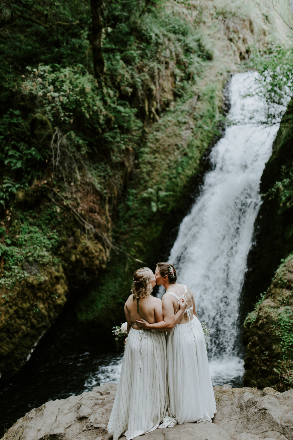 Audrey and Kate kiss. Elopement wedding photography at Bridal Veil Falls by Sienna Plus Josh.