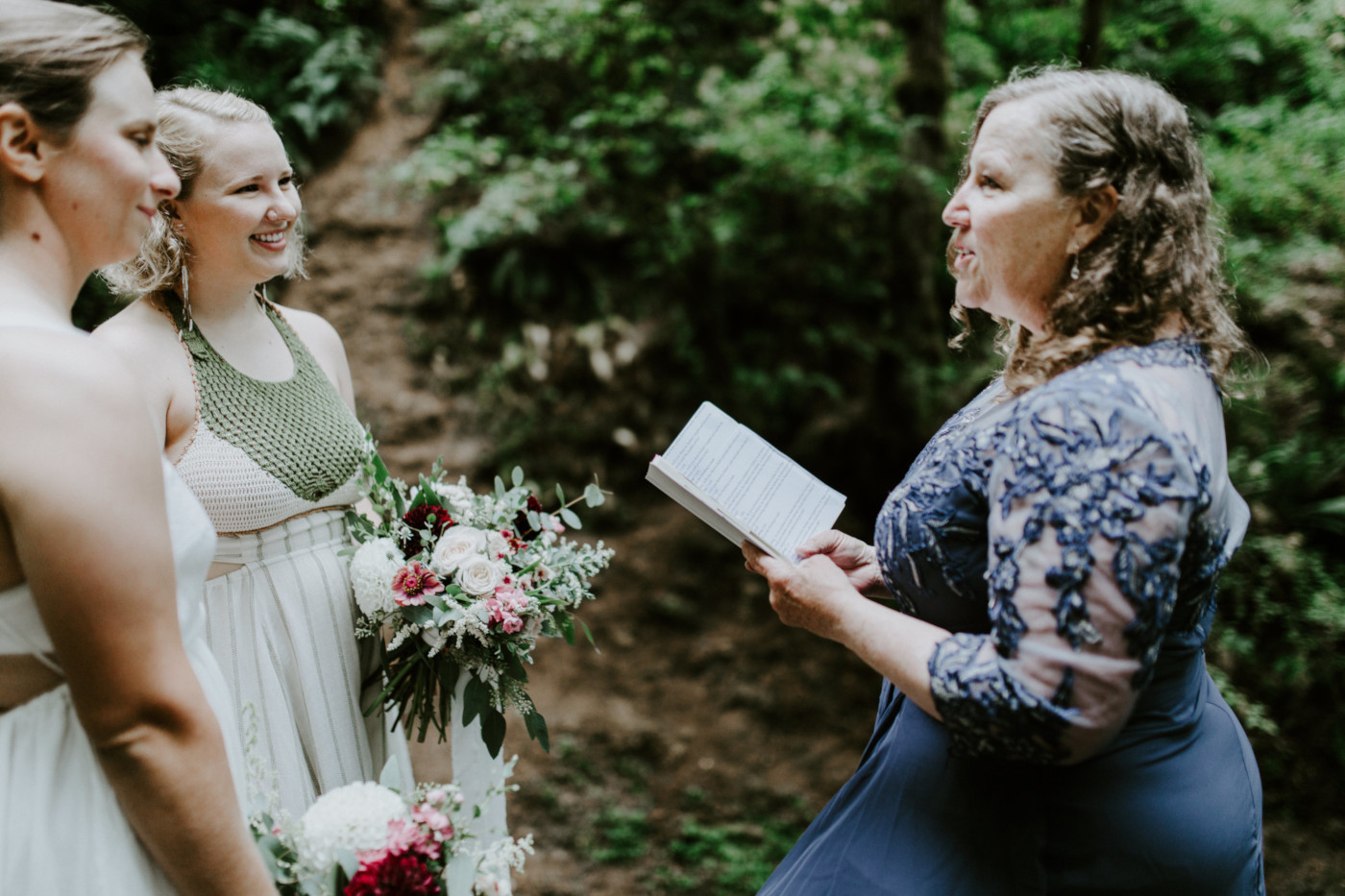 Kate's mom officiates Kate and Audrey's elopement. Elopement wedding photography at Bridal Veil Falls by Sienna Plus Josh.