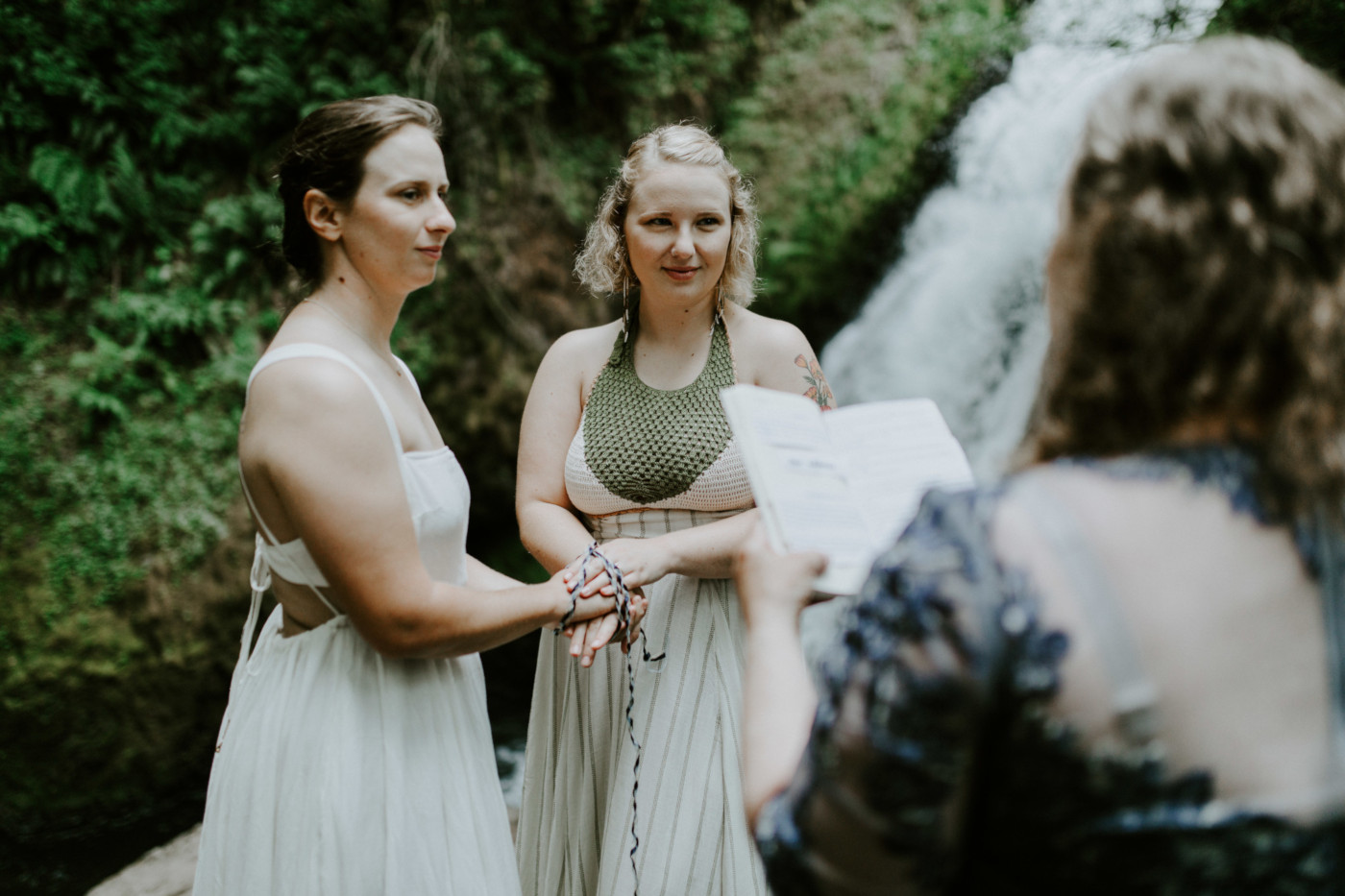 Kate and Audrey during their elopement ceremony at Bridal Veil Falls. Elopement wedding photography at Bridal Veil Falls by Sienna Plus Josh.