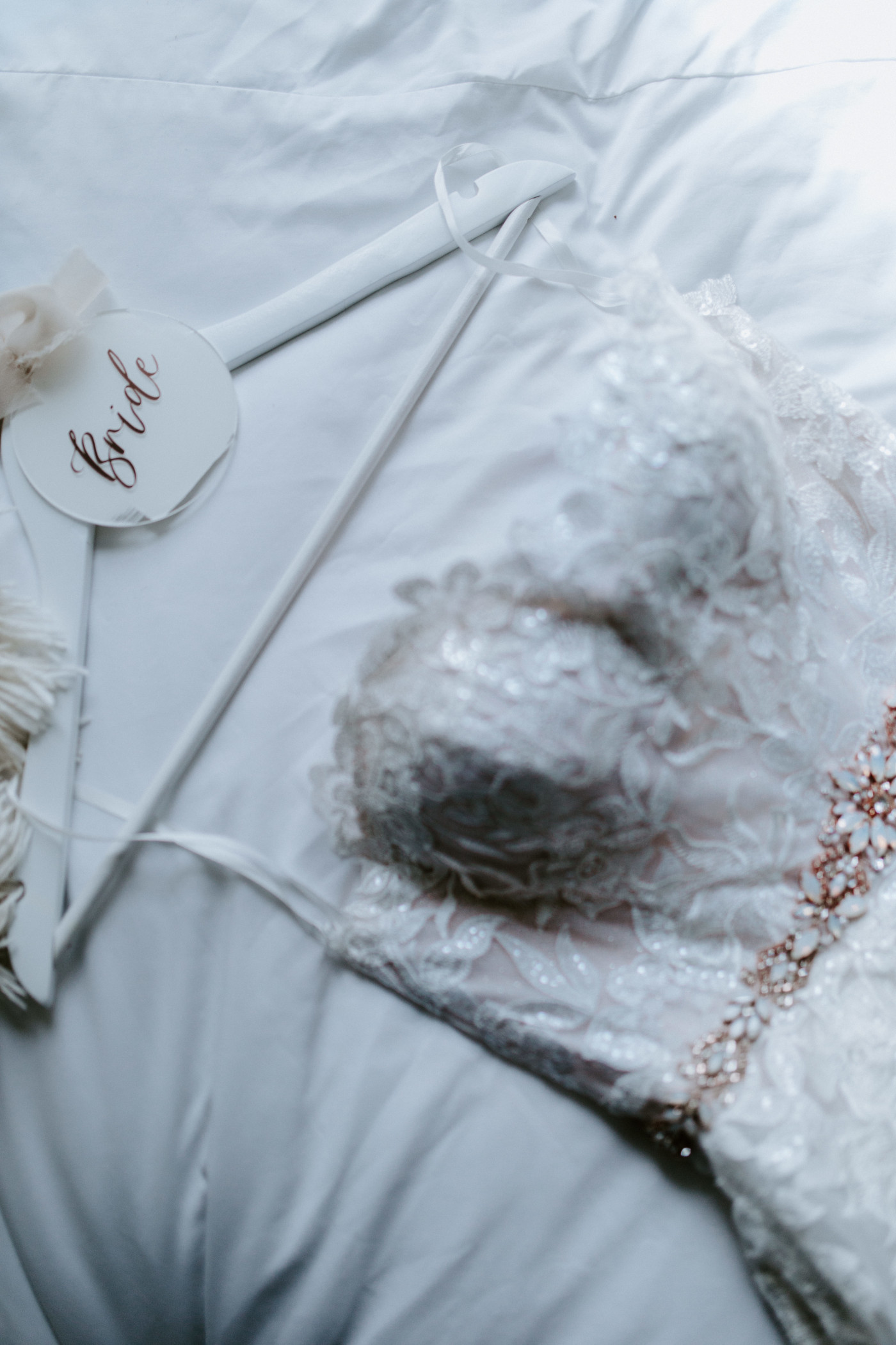 Hannah's bridal dress sits on a bed in her Airbnb.