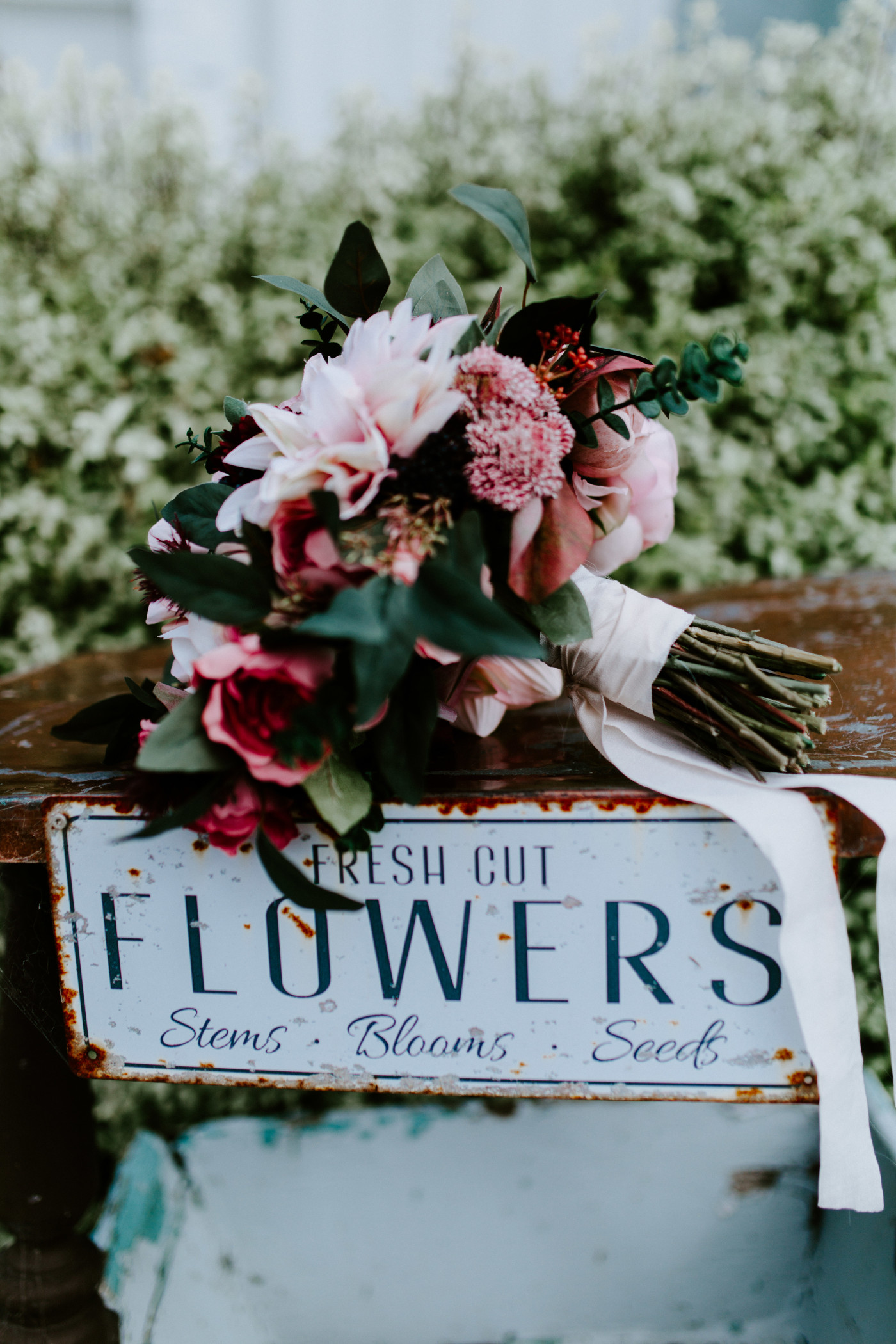 Hannah's flowers sit on top of a sign.