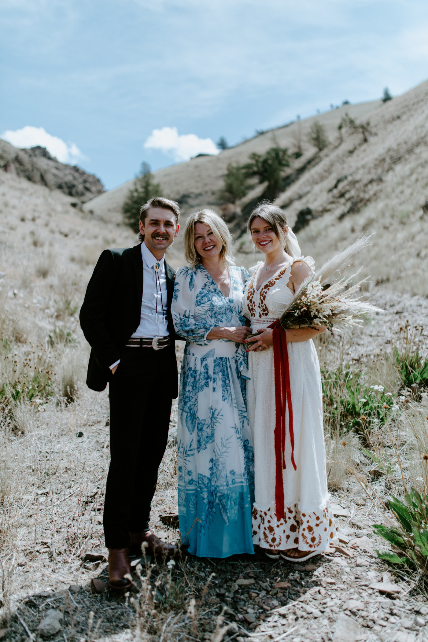 Greyson and Emily take a picture with Emily's mom. Elopement photography in the Central Oregon desert by Sienna Plus Josh.