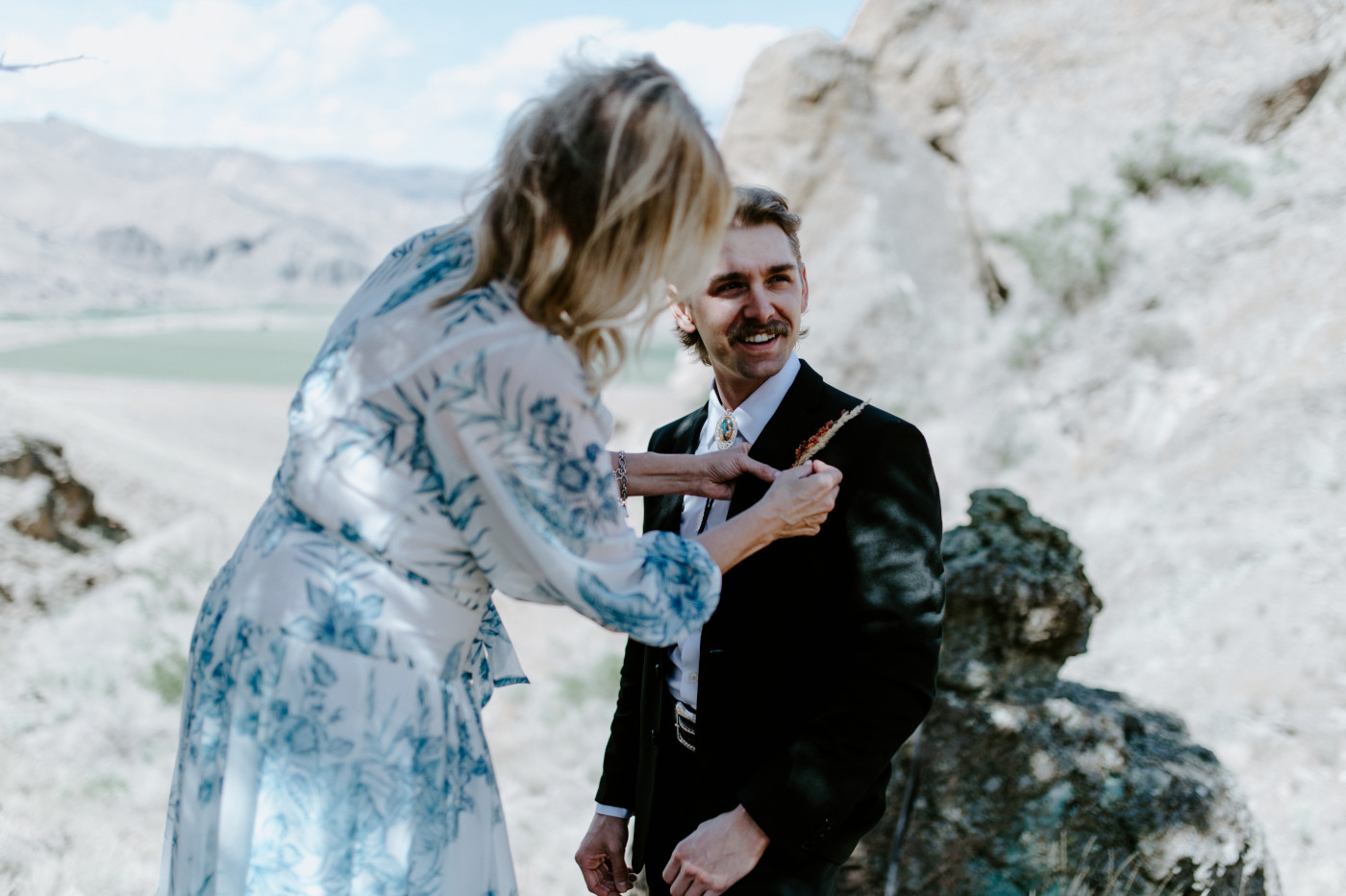 Greyson gets his flowers attached. Elopement photography in the Central Oregon desert by Sienna Plus Josh.