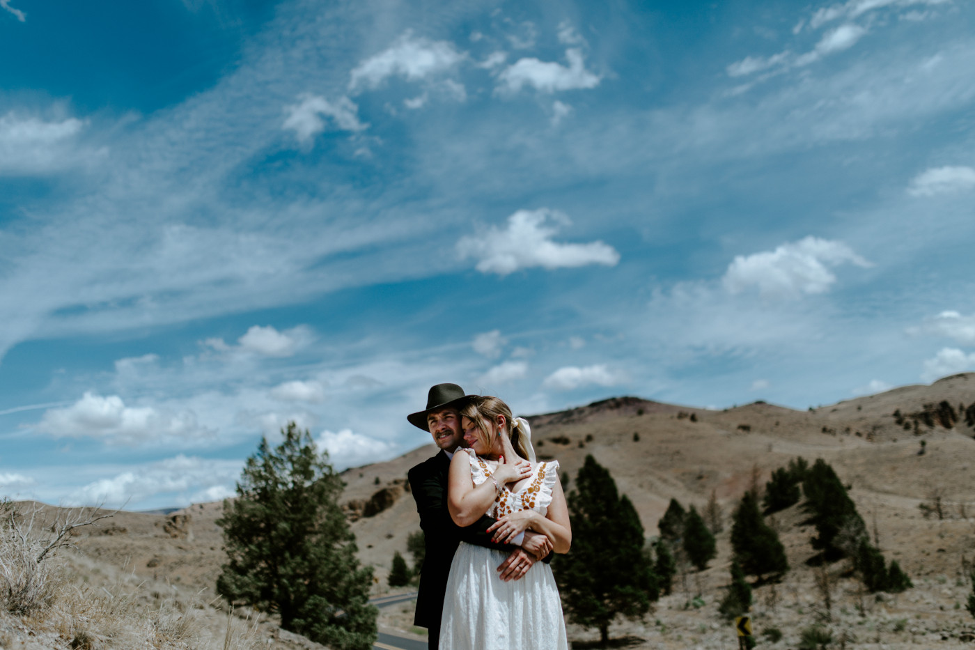 Greyson and Emily hugging. Elopement photography in the Central Oregon desert by Sienna Plus Josh.