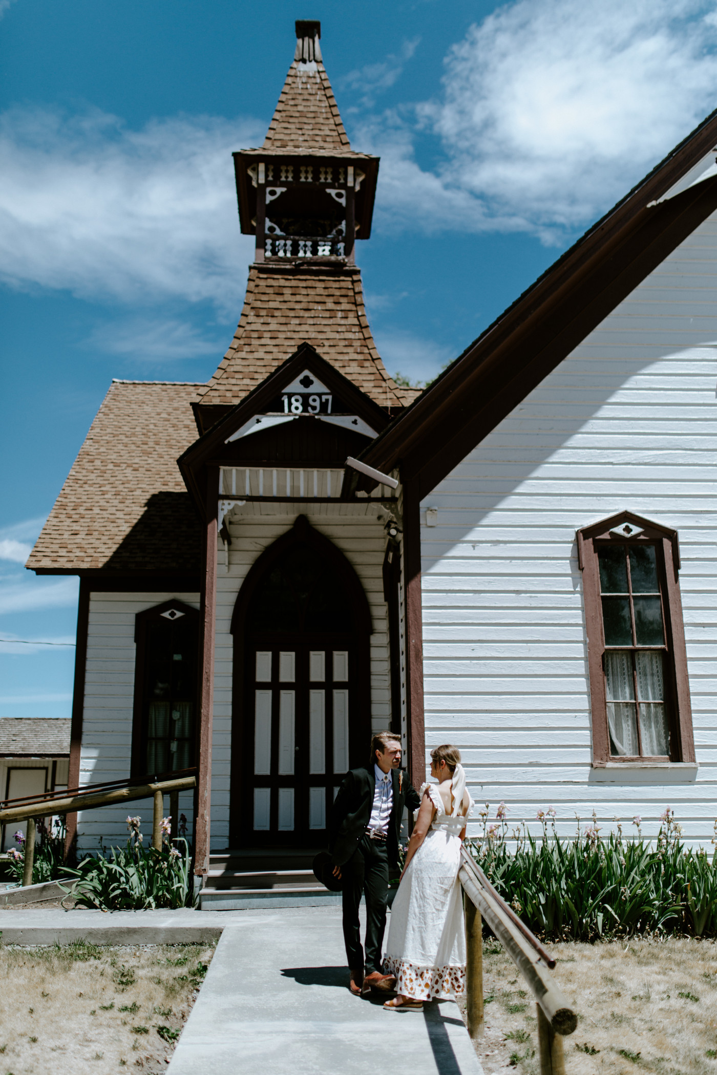 Emily and Greyson hang out in front of a church. Elopement photography in the Central Oregon desert by Sienna Plus Josh.