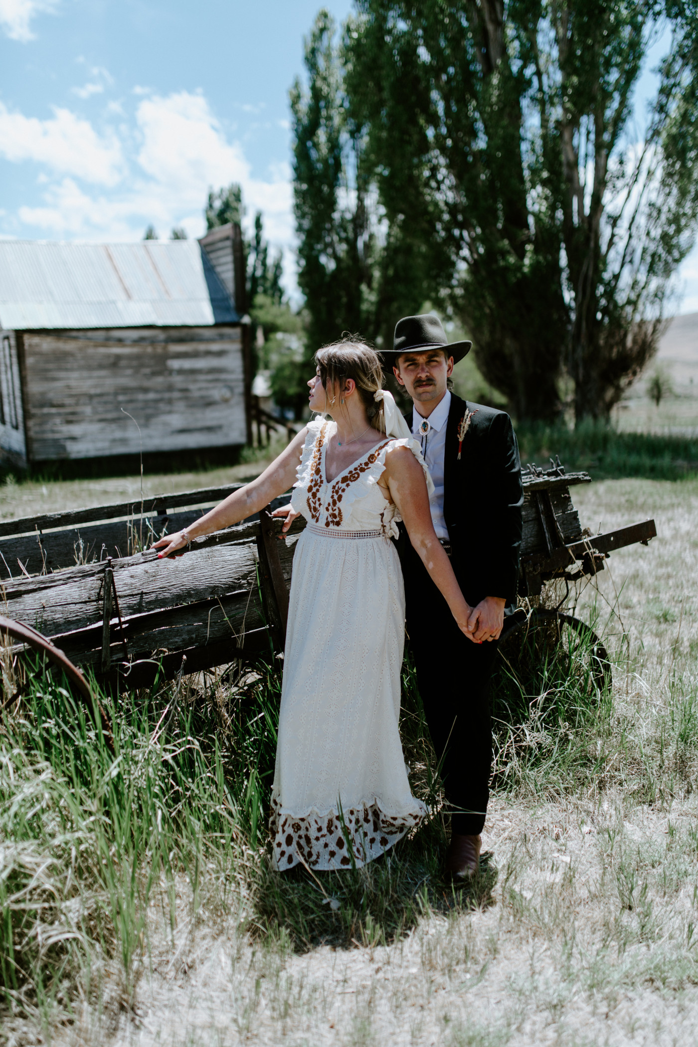 Greyson and Emily in a field. Elopement photography in the Central Oregon desert by Sienna Plus Josh.