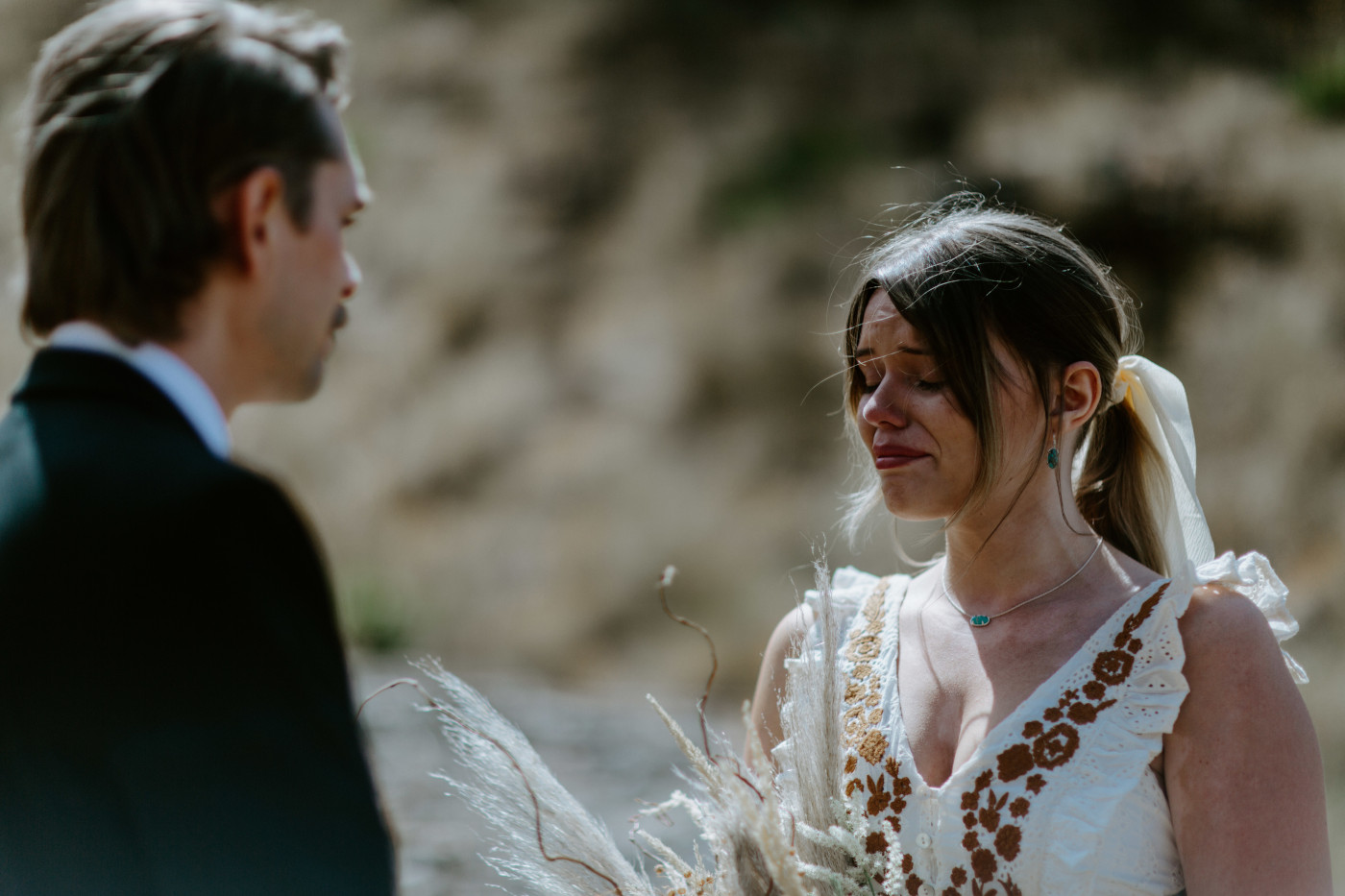 Emily listens to Greyson recite vows. Elopement photography in the Central Oregon desert by Sienna Plus Josh.