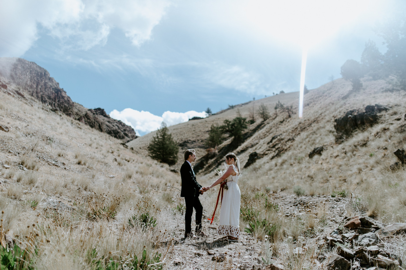 Greyson listens to Emily. Elopement photography in the Central Oregon desert by Sienna Plus Josh.