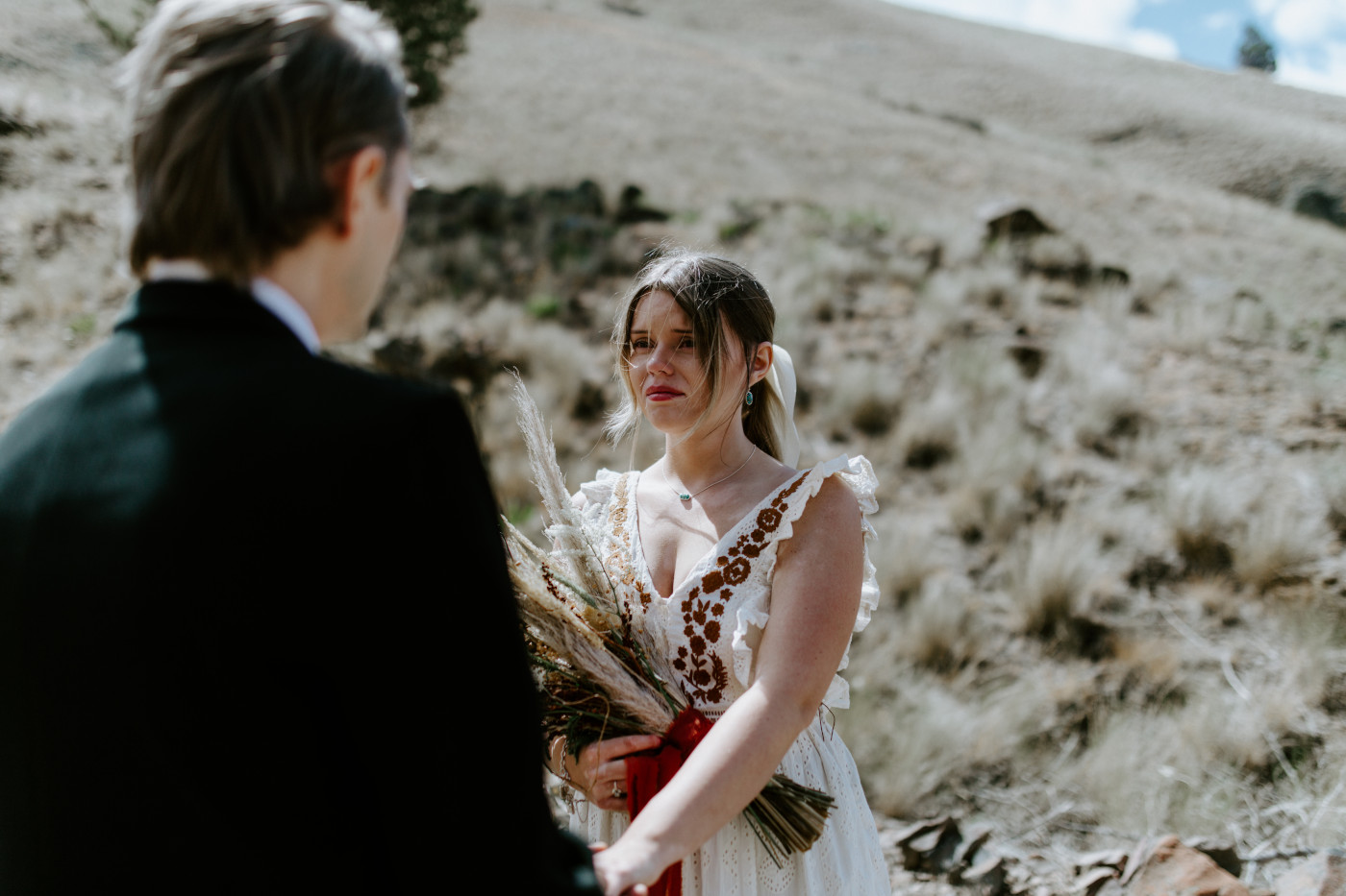Emily looks at Greyson during their elopement. Elopement photography in the Central Oregon desert by Sienna Plus Josh.