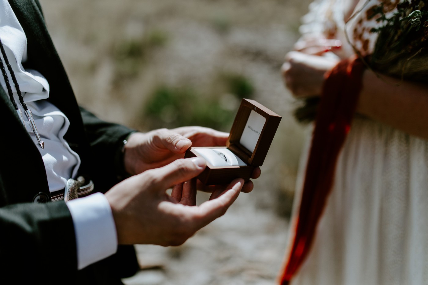 Greyson holds the ring. Elopement photography in the Central Oregon desert by Sienna Plus Josh.