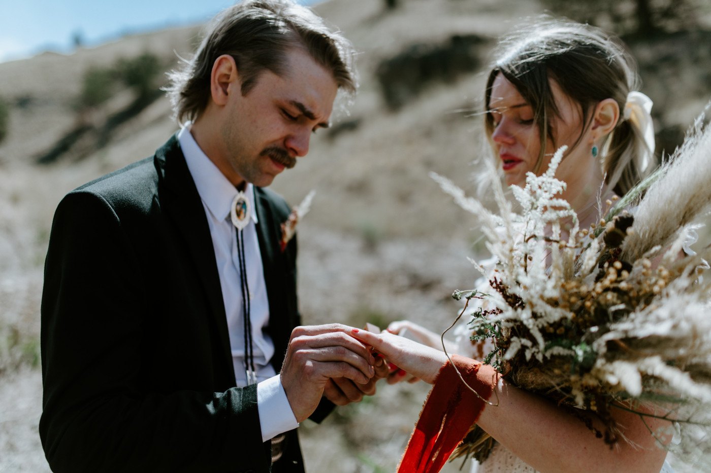 Greyson holds Emilys hand. Elopement photography in the Central Oregon desert by Sienna Plus Josh.