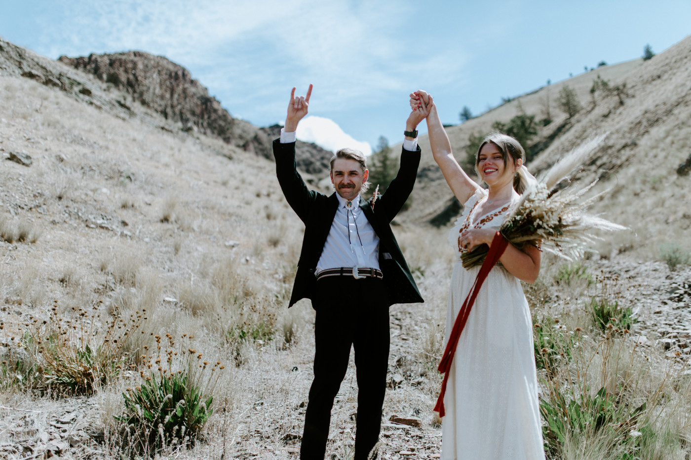 Greyson and Emily celebrate after their ceremony. Elopement photography in the Central Oregon desert by Sienna Plus Josh.
