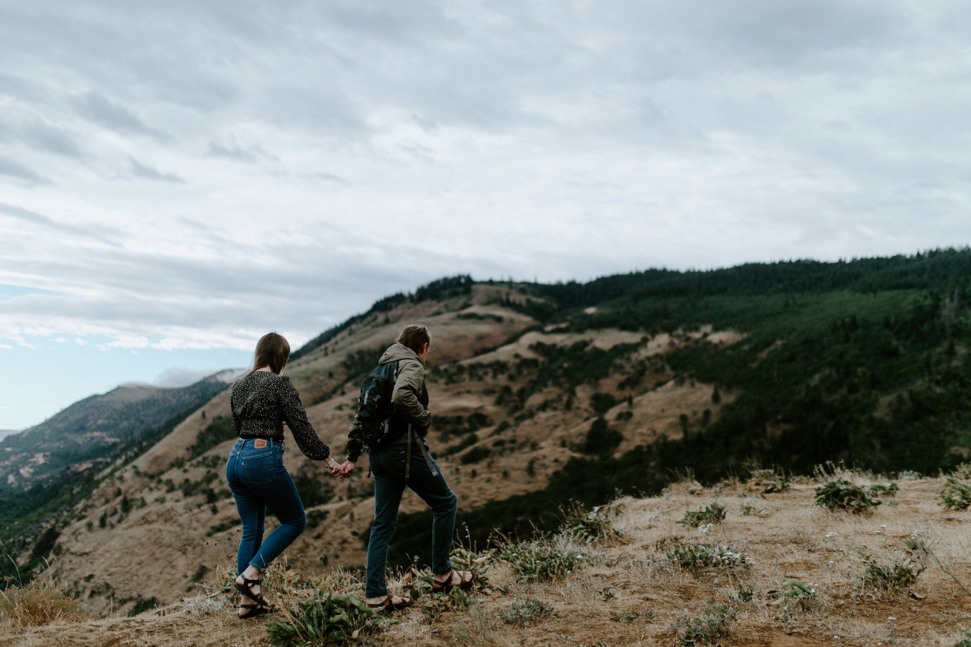 Emily and Greyson walk along the edge of Rowena Crest. Elopement photography at Rowena Crest by Sienna Plus Josh.