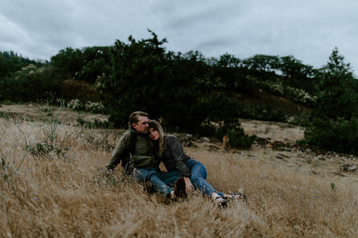 Emily and Greyson sit in the grass. Elopement photography at Rowena Crest by Sienna Plus Josh.