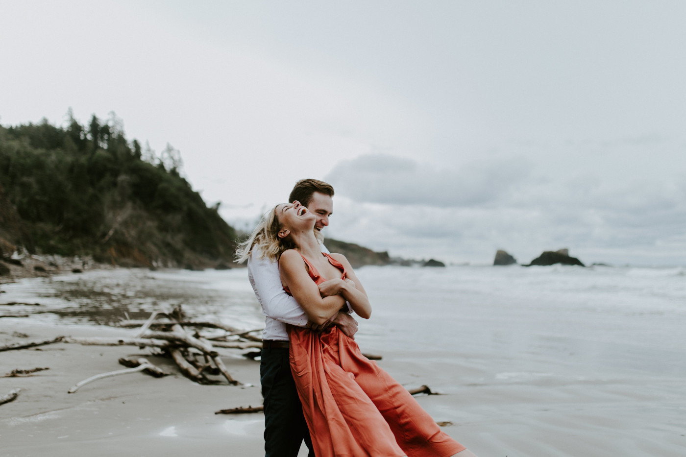 Billy swings Chelsey on the beach. Elopement wedding photography at Cannon Beach by Sienna Plus Josh.