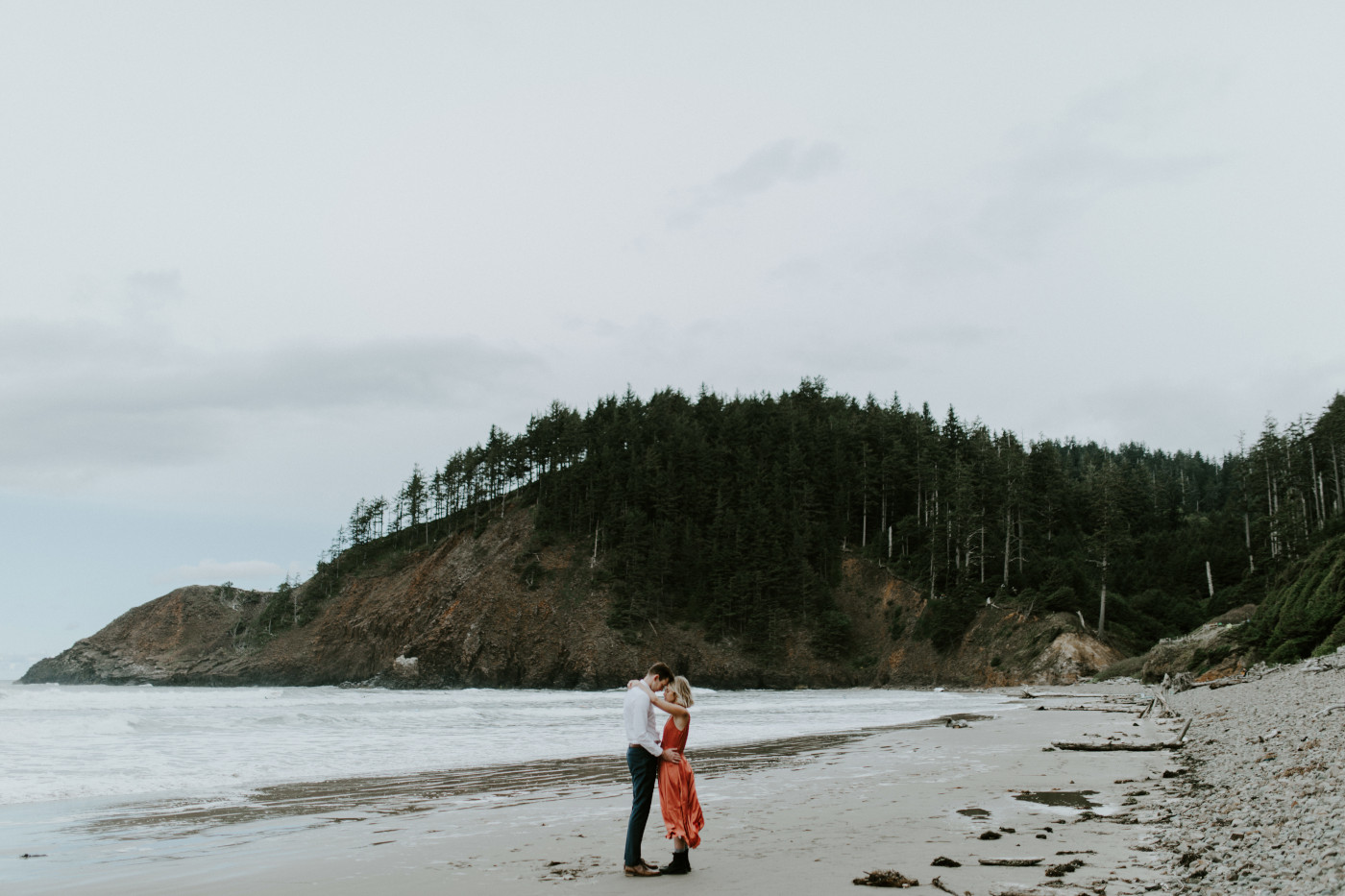 Billy and Chelsey stand together alone at Cannon Beach. Elopement wedding photography at Cannon Beach by Sienna Plus Josh.