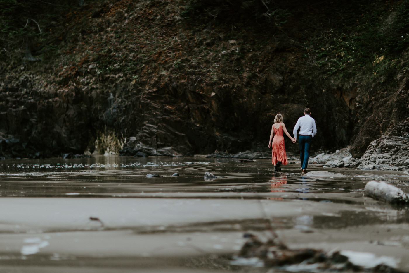 Chelsey and Billy walk along Cannon Beach. Elopement wedding photography at Cannon Beach by Sienna Plus Josh.
