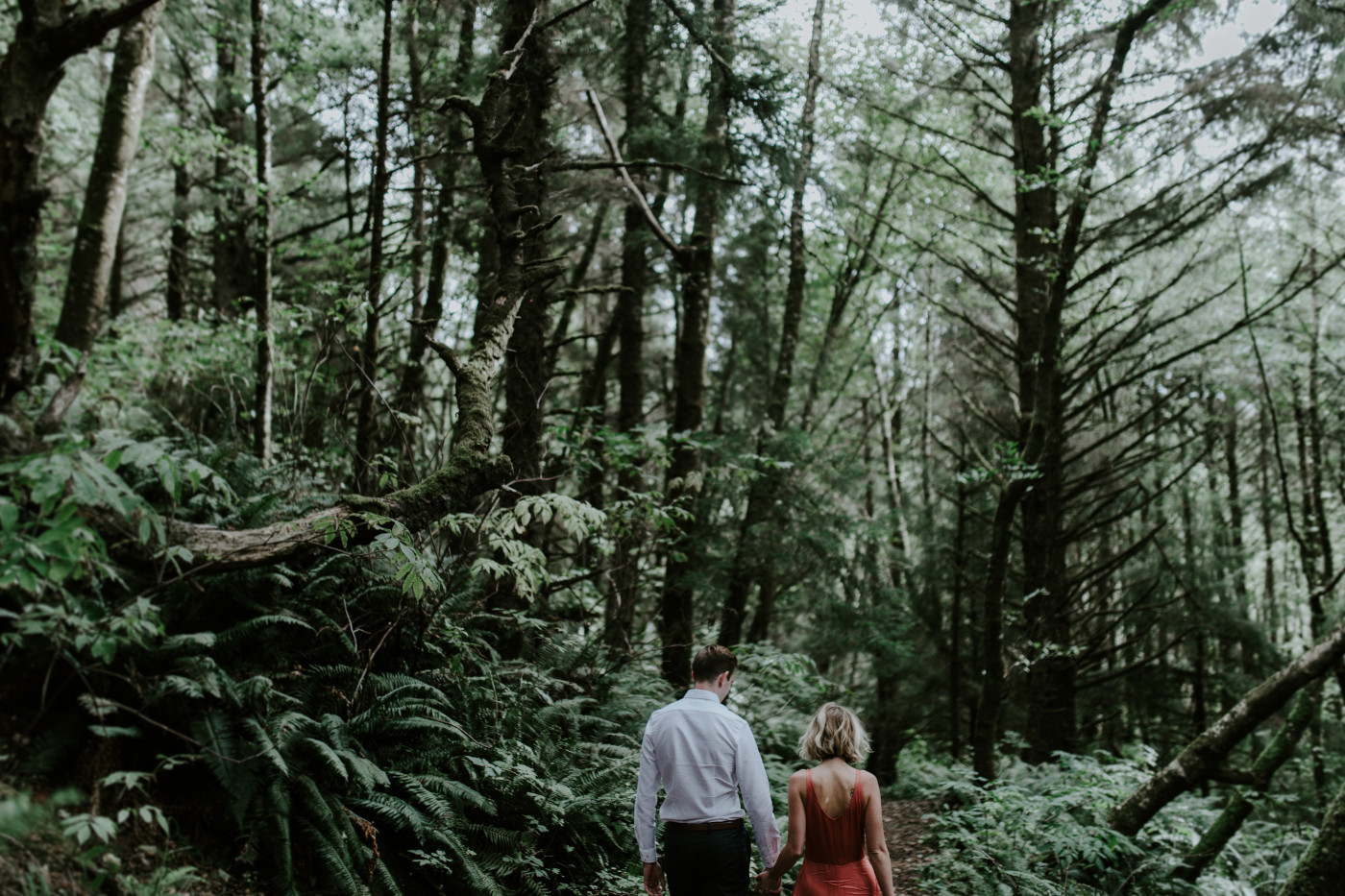 Chelsey and Billy walk along the trail. Elopement wedding photography at Cannon Beach by Sienna Plus Josh.