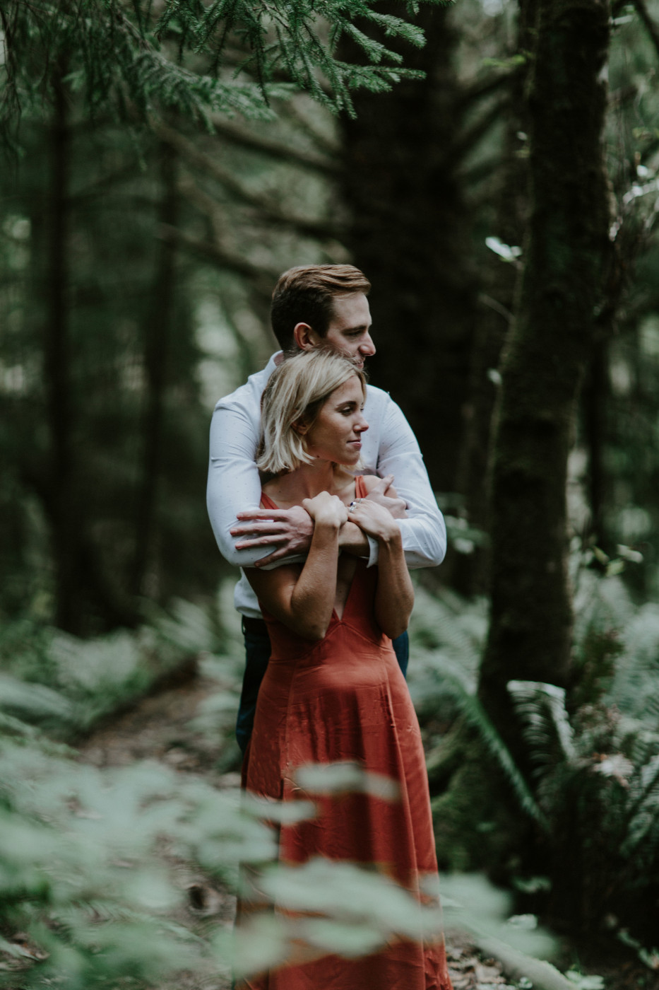 Chelsey hugs Billy from behind. Elopement wedding photography at Cannon Beach by Sienna Plus Josh.