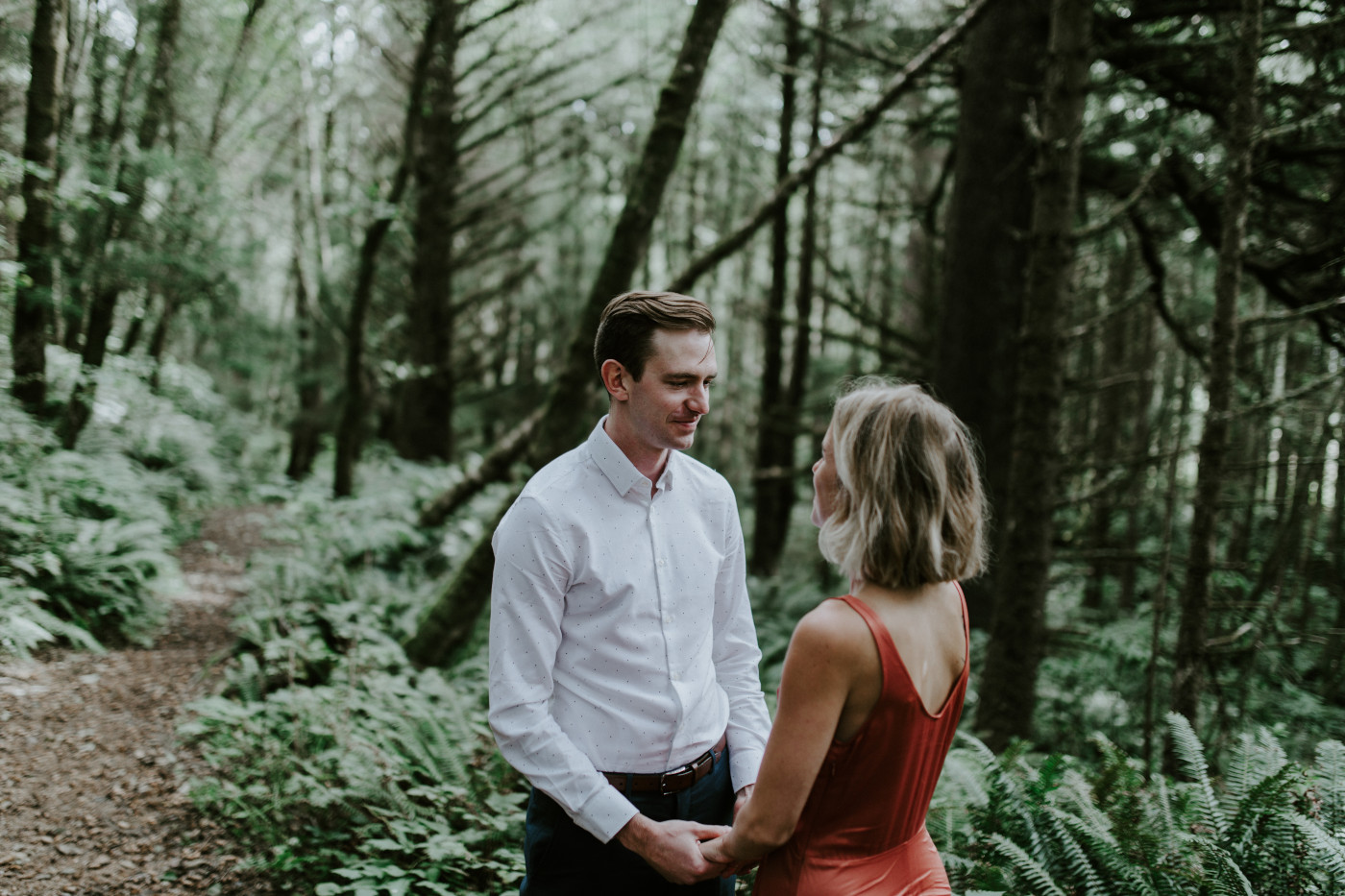 Billy holds Chelsey's hands. Elopement wedding photography at Cannon Beach by Sienna Plus Josh.