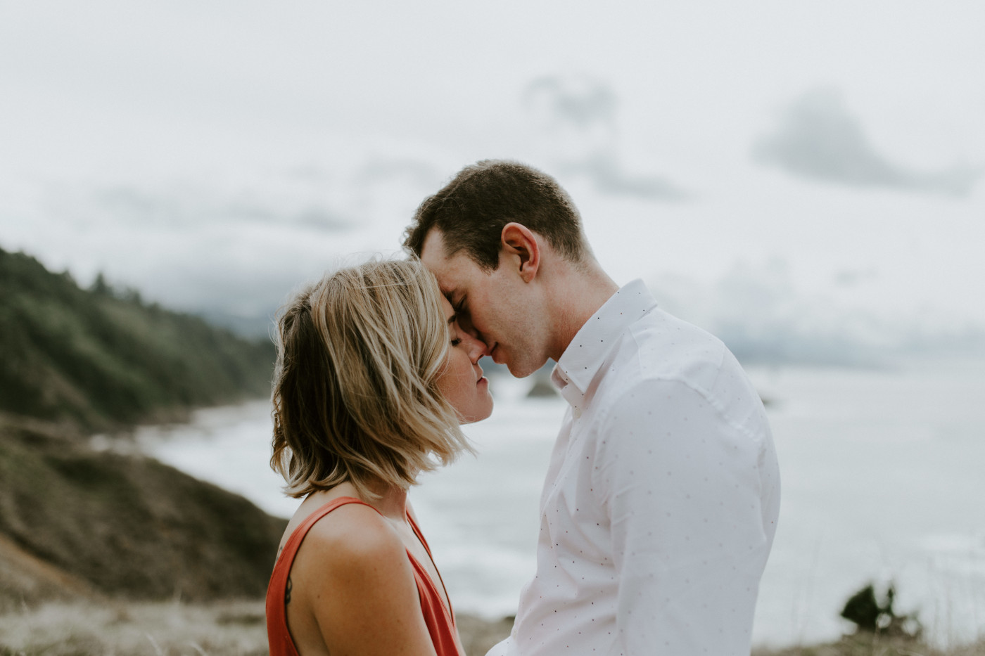 Billy and Chelsey put their foreheads together in front of Cannon Beach. Elopement wedding photography at Cannon Beach by Sienna Plus Josh.