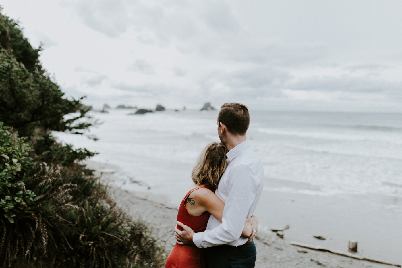 Chelsey hugs billy on the beach at Cannon Beach. Elopement wedding photography at Cannon Beach by Sienna Plus Josh.