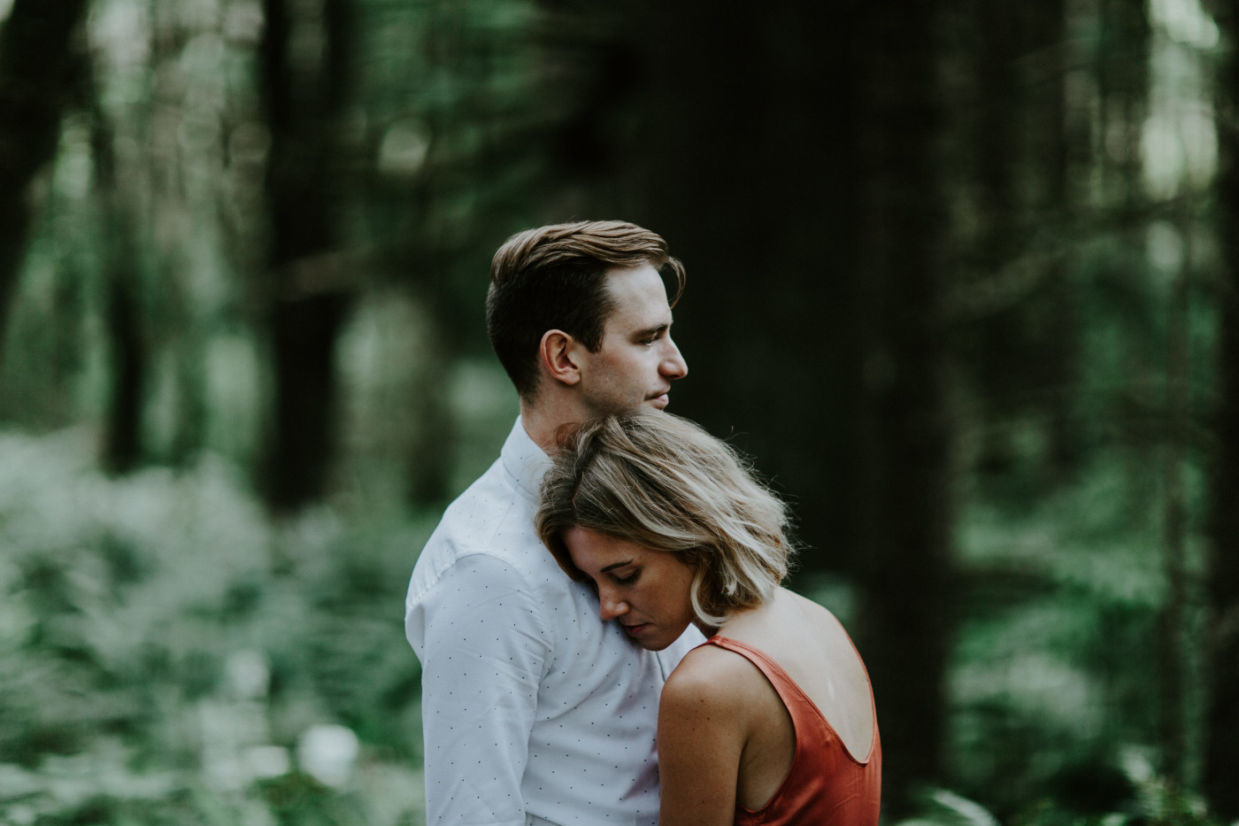 Chelsey rests her head on Billy's chest. Elopement wedding photography at Cannon Beach by Sienna Plus Josh.