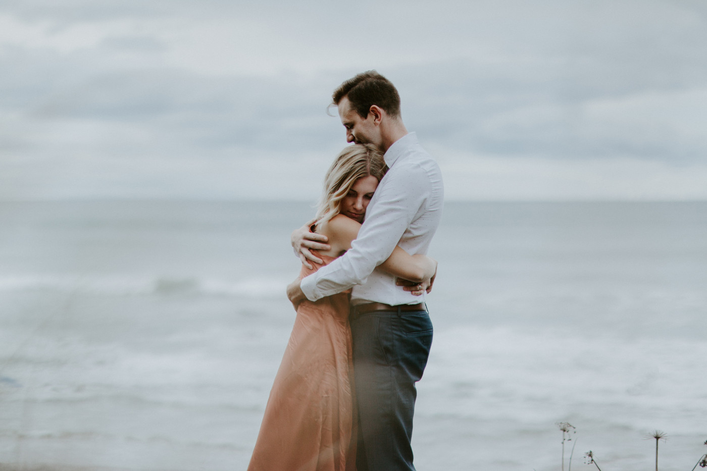 Billy and Chelsey hug at Cannon Beach. Elopement wedding photography at Cannon Beach by Sienna Plus Josh.