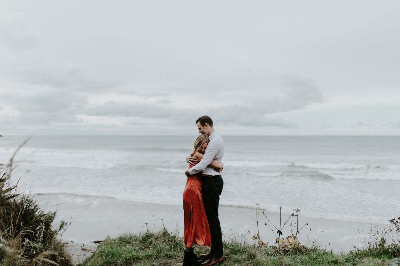 Billy and Chelsey stand near the beach. Elopement wedding photography at Cannon Beach by Sienna Plus Josh.