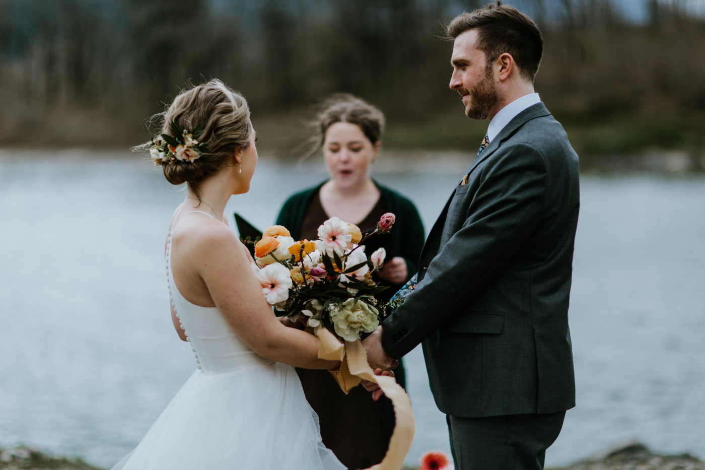 Lennie and Allison hold hands at the altar. Elopement photography at Columbia River Gorge by Sienna Plus Josh.