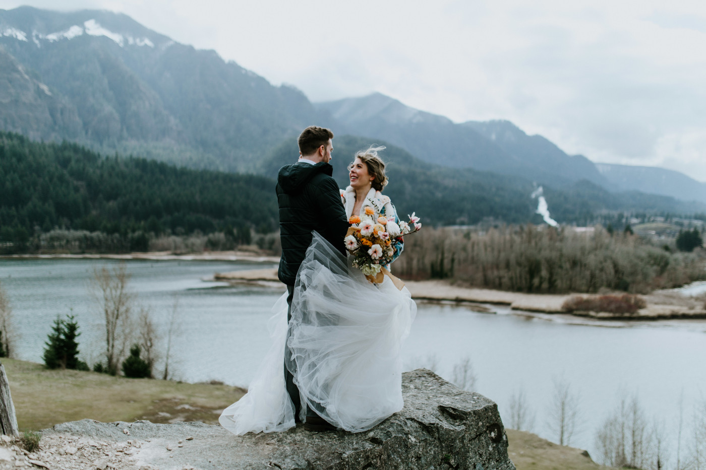 Allison and Lennie stand near a windy cliff. Elopement photography at Columbia River Gorge by Sienna Plus Josh.